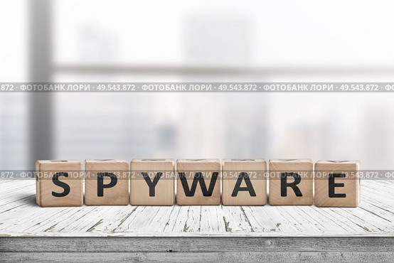 Spyware word on wooden cubes in a bright office on a white painted desk. Стоковое фото, агентство Ingram Publishing / Фотобанк Лори
