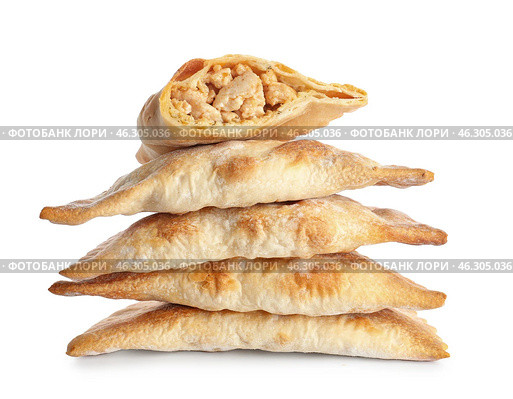 Stack of baked meat empanadas on white background. Стоковое фото, фотограф Pixel_shot / Фотобанк Лори