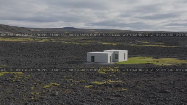 Stark white architectural design contrasting volcanic black terrain, nestled among rugged Icelandic mountain peaks beneath overcast skies. Стоковое AI-видео, аниматор Данил Руденко / Фотобанк Лори