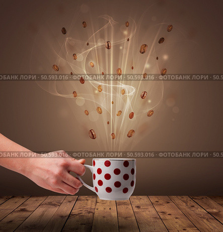 Steaming cup of coffee and coffee beans. Стоковое фото, агентство Ingram Publishing / Фотобанк Лори