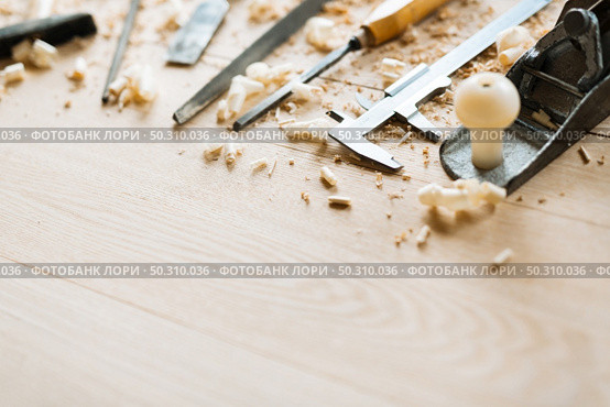 Still life of carpentry tools on wooden table background, shaving scattered everywhere, close-up shot. Стоковое фото, агентство Ingram Publishing / Фотобанк Лори