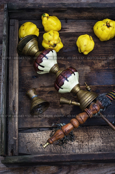 Still life with retro hookah and quince. Stylish hookah disassembled in wooden box with fragrant autumn fruit quince. Стоковое фото, агентство Ingram Publishing / Фотобанк Лори