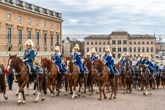STOCKHOLM, SWEDEN - APRIL 30, 2018: Royal Guard cavalry on horses in blue uniforms. The celebration of King Carl XVI Gustaf 72 years old, at the Royal Palace in Stockholm. Редакционное фото, фотограф Сергей Комаров / Фотобанк Лори