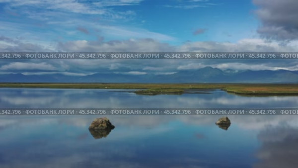 Stones with reflection in smooth water. Стоковое видео, видеограф Михаил Коханчиков / Фотобанк Лори