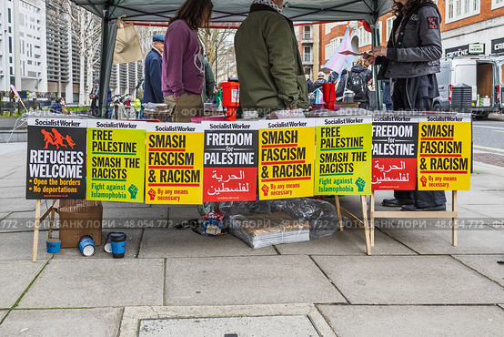 Street protest with colorful signs and banners. London, UK, 16 March 2024. Редакционное фото, фотограф Zydrius Tartenis / Фотобанк Лори