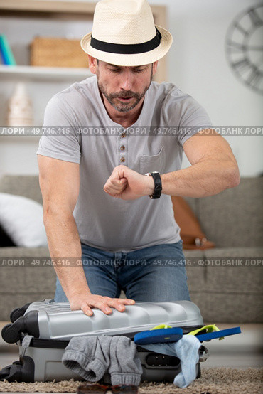 stressed man packing suitcase in a hurry. Стоковое фото, агентство Ingram Publishing / Фотобанк Лори