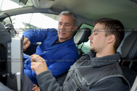student with instructor repairing a car during apprenticeship. Стоковое фото, агентство Ingram Publishing / Фотобанк Лори