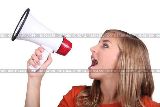 Studio shot of a girl shouting into a megaphone. Стоковое фото, агентство Ingram Publishing / Фотобанк Лори