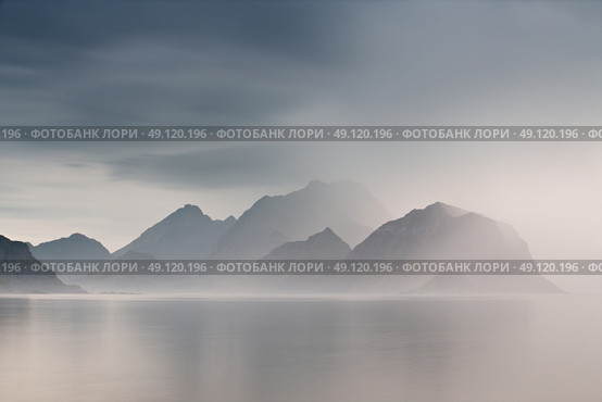 Summer cloudy Lofoten islands. Norway misty sea and fjords. Nordic rain. Стоковое фото, агентство Ingram Publishing / Фотобанк Лори