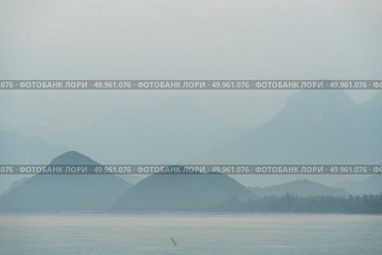 Sunrise and mountain beside the sea at khao sam roi yot national park, Thailand. Стоковое фото, агентство Ingram Publishing / Фотобанк Лори