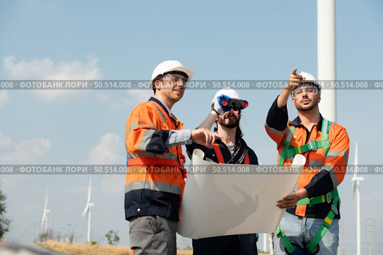 Surveyor and engineer Examine the efficiency of gigantic wind turbines that transform wind energy into electrical energy that is then used in daily life. Стоковое фото, агентство Ingram Publishing / Фотобанк Лори