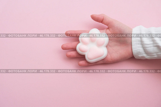 Taba paw pink and white colorful anti-stress toys squirt on baby's hand. Стоковое фото, фотограф Терехова Марина / Фотобанк Лори