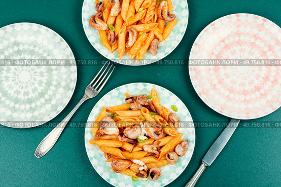 Tasty macaroni or pasta cooked with octopus. Greek food recipe. Italian restaurant food.. Seafood pasta with octopus. Стоковое фото, агентство Ingram Publishing / Фотобанк Лори