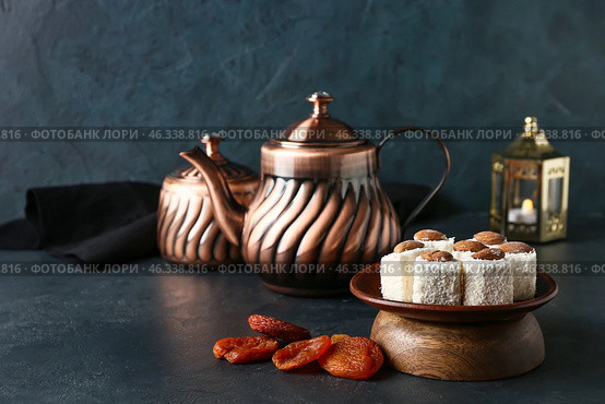 Tasty Turkish delight with dried apricots and tea on dark background. Стоковое фото, фотограф Pixel_shot / Фотобанк Лори