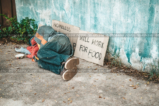 The beggars lay on their side of the street with dirty clothes. Стоковое фото, агентство Ingram Publishing / Фотобанк Лори