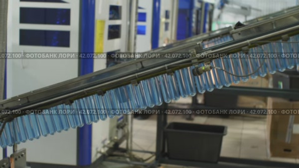The blue molds are sent along the conveyor to the bottle blowing machine. Plant for the production of drinking and mineral water. Стоковое видео, видеограф Воловодов Владимир / Фотобанк Лори