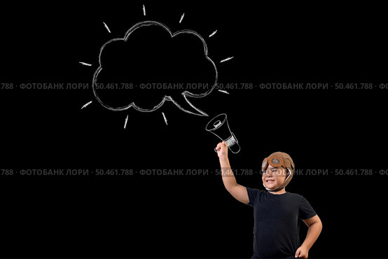 The boy pretends to be a superhero and uses a megaphone to amplify the sound. Draw concept. Стоковое фото, агентство Ingram Publishing / Фотобанк Лори