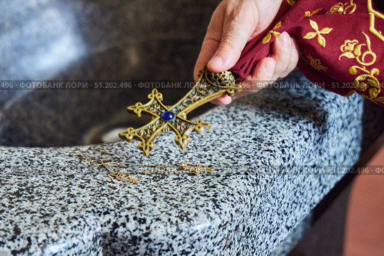 The cross is in the hands of a priest. The Sacrament of baptism, close-up. Armenian Apostolic Church. Стоковое фото, фотограф Наталия Кирсанова / Фотобанк Лори