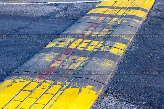The Faded Yellow Crosswalk on the Asphalt Surface within the urban environment stands out distinctly. Стоковое фото, фотограф Аксенова Вера / Фотобанк Лори