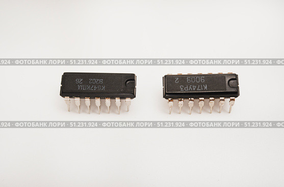 The microcircuit. An old microcircuit on a white background. An electronic device. Стоковое фото, фотограф Valeriy Lushchikov / Фотобанк Лори
