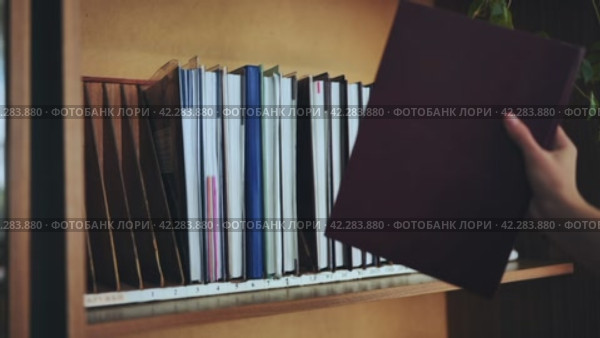 The teacher takes a school teacher's magazine from the shelf. Стоковое видео, видеограф Mikhail Davidovich / Фотобанк Лори