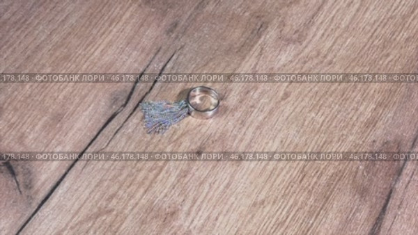 The woman takes a ring with a tassel pendant from the table. Close-up. Стоковое видео, видеограф Vadzim Yakubovich / Фотобанк Лори