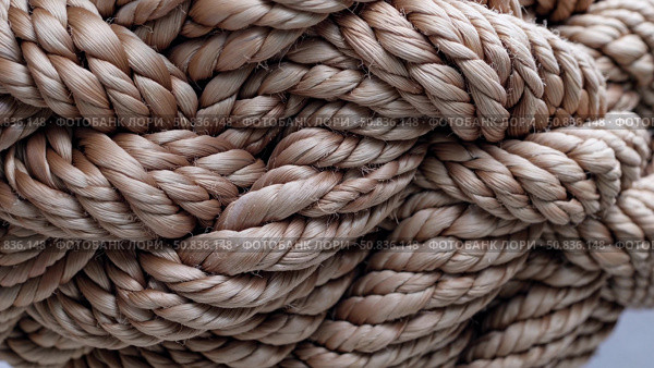 Tightly woven rope fibers interlocking in complex knot, revealing textural detail and robust strength of nautical cordage with warm earthy coloration. Стоковое AI-изображение, AI-художник Данил Руденко / Фотобанк Лори