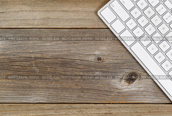 Top view of a partial computer keyboard on rustic wood. Стоковое фото, агентство Ingram Publishing / Фотобанк Лори