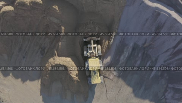 Top view of a sand quarry with a bulldozer working with concrete. Стоковое видео, видеограф Николай Титюк / Фотобанк Лори