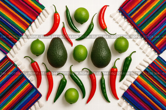 Top view of avocados, limes, and red and green chili peppers arranged with colorful Mexican woven textiles on white background. Стоковое AI-изображение, AI-художник Башкирова Анна / Фотобанк Лори