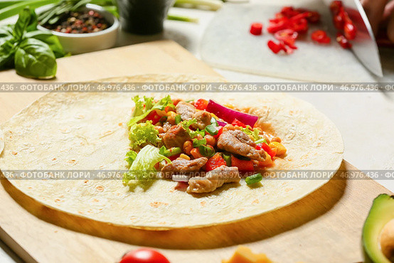 Тортильи со свежими ингредиентами для приготовления вкусного буррито на белом фоне. Стоковое фото, фотограф Pixel_shot / Фотобанк Лори