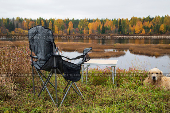 Tourist collapsible chair on the background of the autumn landscape. Стоковое фото, фотограф Александр Поташев / Фотобанк Лори