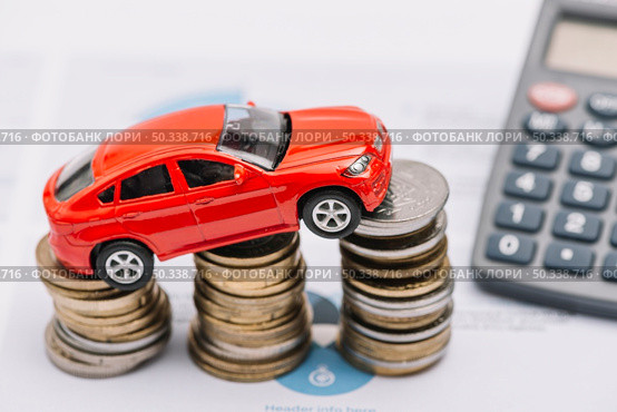 toy car balancing increasing coin stack. Стоковое фото, агентство Ingram Publishing / Фотобанк Лори