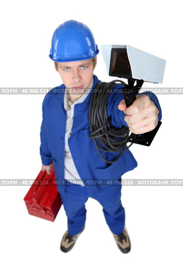 Tradesman holding a surveillance camera. Стоковое фото, агентство Ingram Publishing / Фотобанк Лори