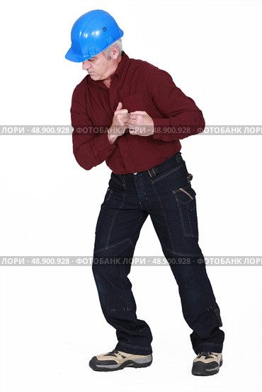 Tradesman staring at the floor. Стоковое фото, агентство Ingram Publishing / Фотобанк Лори