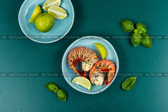 Traditional barbecue spiny lobster tail sliced and offered with saffron lemon sauce.. Broiled lobster tail, tasty steamed lobster. Стоковое фото, агентство Ingram Publishing / Фотобанк Лори