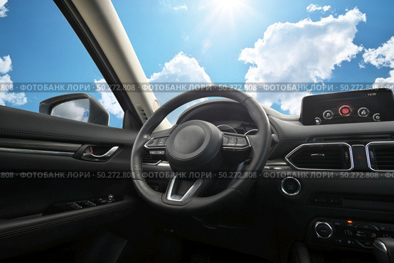 Travel in car. Element of design. Dashboard panel inside automobile and sky background. Behind the wheel. Стоковое фото, агентство Ingram Publishing / Фотобанк Лори