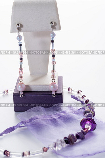 trendy author necklace with rarely gemstone charoite and earrings  around white background. fashion and handmade concept. Стоковое фото, агентство Ingram Publishing / Фотобанк Лори