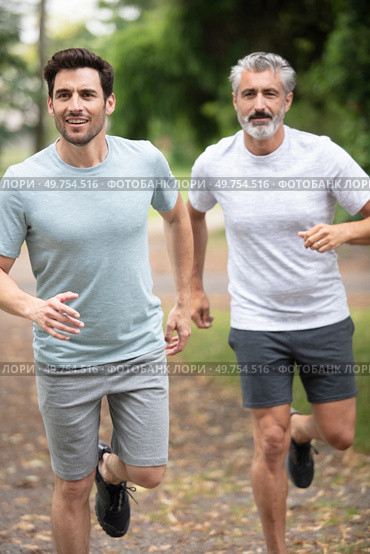 two athletic guys in sportswear running. Стоковое фото, агентство Ingram Publishing / Фотобанк Лори