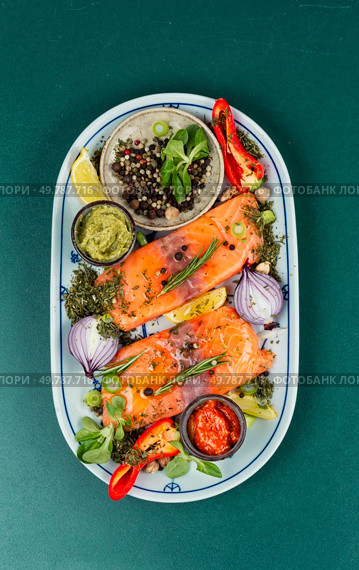 Two uncooked, raw salmon fillets. Spices, sauces and herbs. Fish fillet of salmon and ingredients. Стоковое фото, агентство Ingram Publishing / Фотобанк Лори