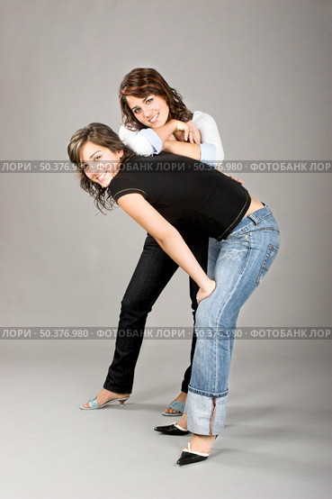 Two young beautiful sisters having fun - This models are true twins. Стоковое фото, агентство Ingram Publishing / Фотобанк Лори
