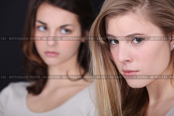 Two young women post-argument. Стоковое фото, агентство Ingram Publishing / Фотобанк Лори