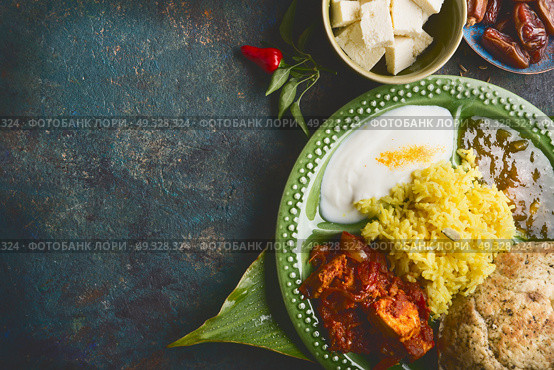 Various indian meal in bowl served on bamboo leaf  on dark rustic background, top view, place for text. Стоковое фото, агентство Ingram Publishing / Фотобанк Лори