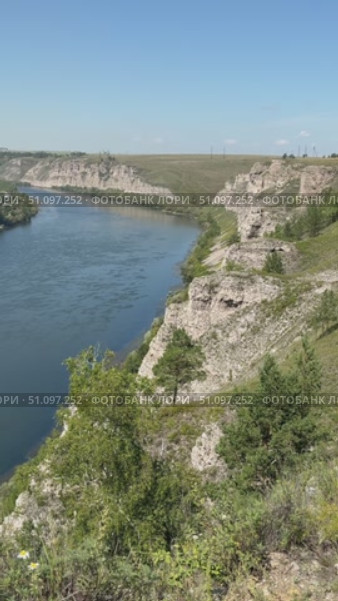 Vertical video of natural landmark - White Rocks along bank of Siberian River Belaya near village of Kholmushino, Usolye-Sibirskoye district. Beautiful summer landscape. Top view. Стоковое видео, видеограф Виктория Катьянова / Фотобанк Лори