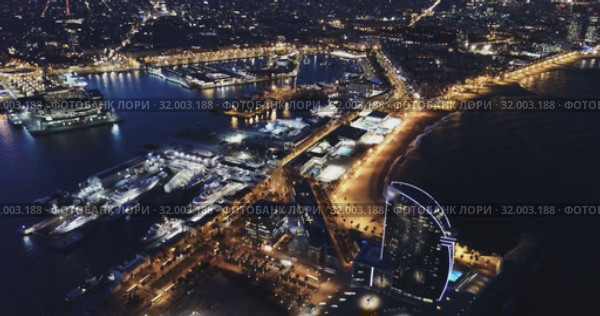 View from drone of illuminated Barceloneta beach with Port Vell t night (2019 год). Стоковое видео, видеограф Яков Филимонов / Фотобанк Лори