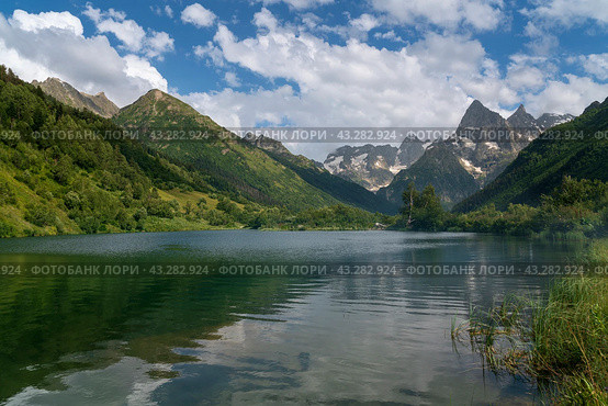 View of Lake Tumanly-Gel (Foggy Lake) in the valley of the Gonachkhir River on the territory of the Teberdinsky National Park on a sunny summer day, Dombay, Karachay-Cherkessia, Russia. Стоковое фото, фотограф Ula Ulachka / Фотобанк Лори