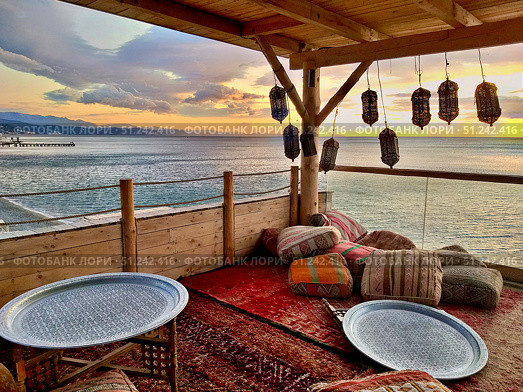 View of the Black Sea from the Tatar-style gazebo on the beach of the city of Alushta (2019 год). Редакционное фото, фотограф Александр Карпенко / Фотобанк Лори