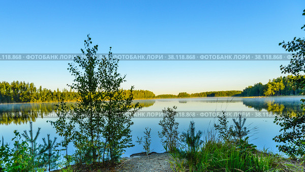 View of the lake from the shore from the shore at sunrise. Morning mist.Haukivesi lake, Saimaa lake system, Savo, Finland. Стоковое фото, фотограф Михаил Аккуратoв / Фотобанк Лори