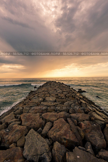 View south of Furadouro beach in Ovar on a stormy day at sunset. Стоковое фото, агентство Ingram Publishing / Фотобанк Лори