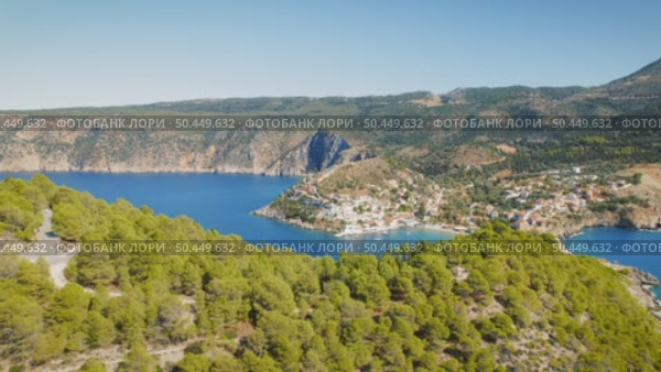 Village of Assos nestled between forested hills and twin bays in Kefalonia Greece. Стоковое видео, видеограф Igor Tichonow / Фотобанк Лори